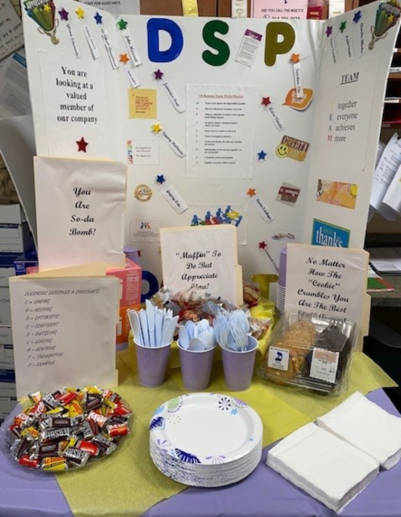 A white board display for DSP week with candy and treats in front of it. 