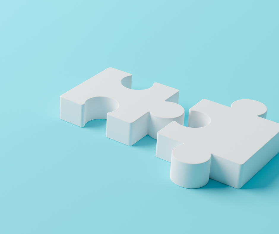 Two puzzle pieces about to connect on a blue background