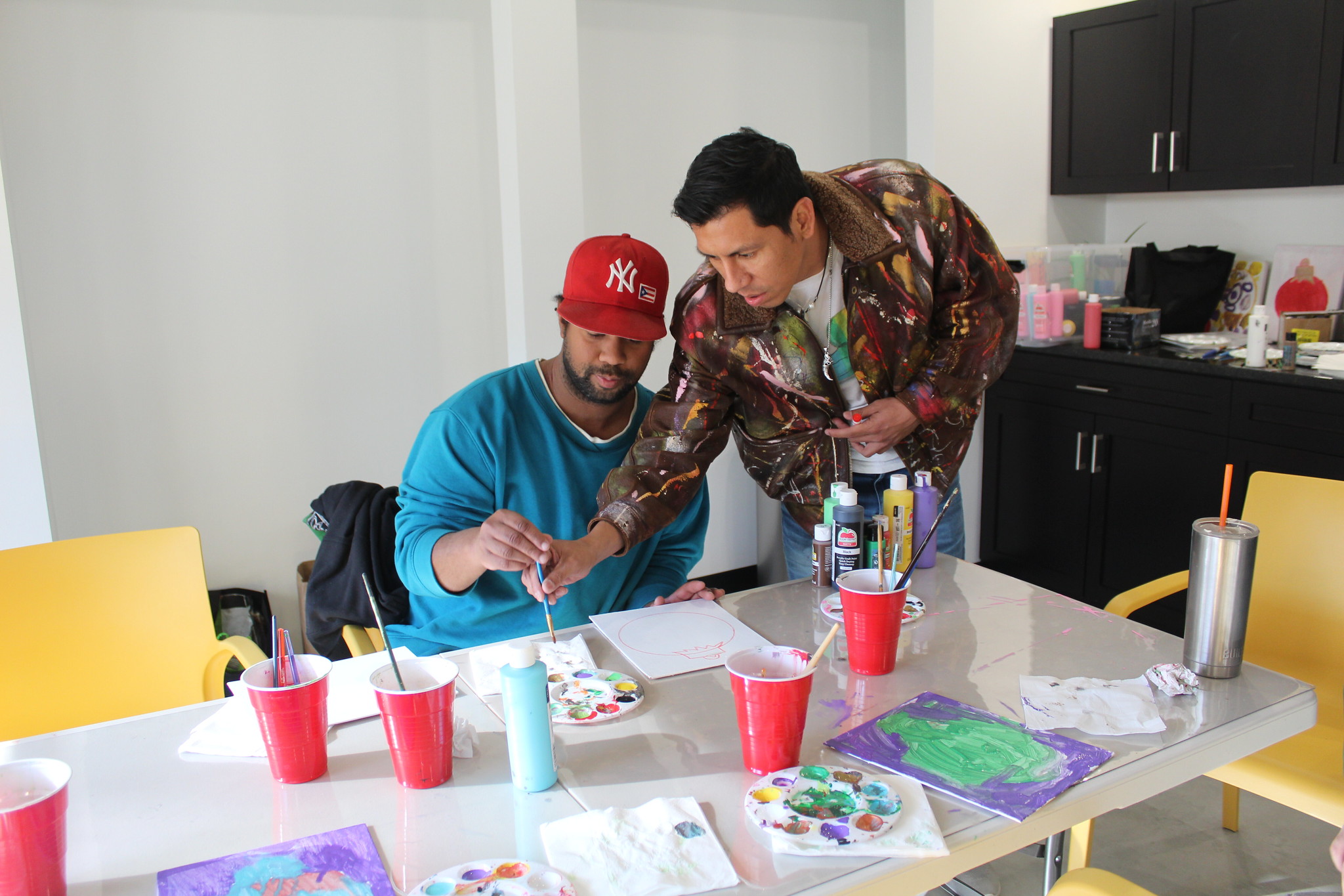 Muralist Rene Soto works with a student