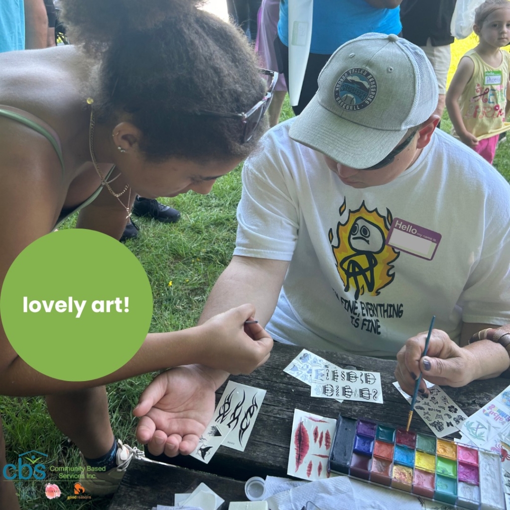 CBS friends with disabilities and autism do art and temporary tattoos at the art table during Field Day.