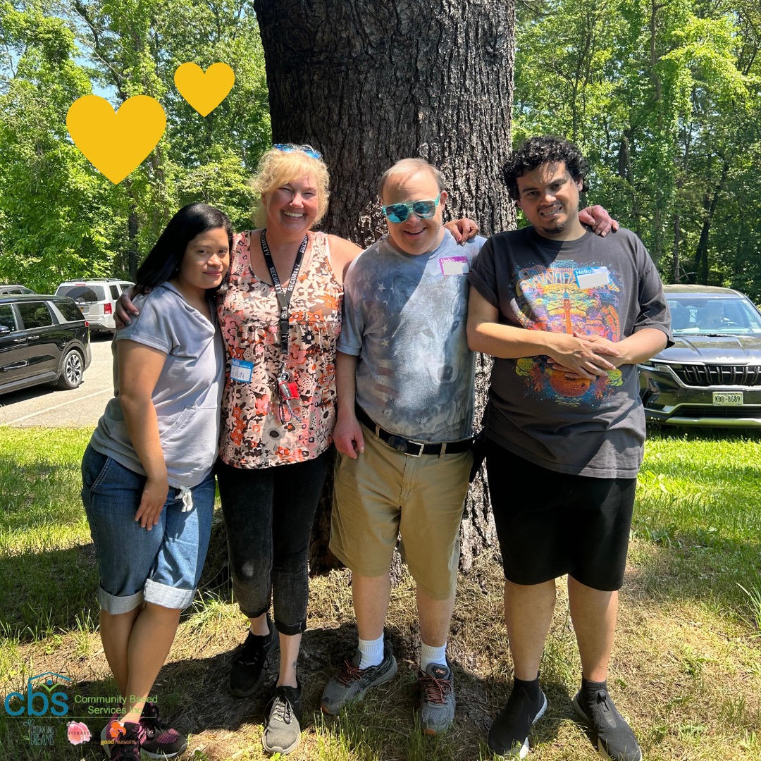 Friends, individuals with disabilities and autism, and direct support professionals hug, enjoying each others company and the beautiful day during Field Day at FDR Park.
