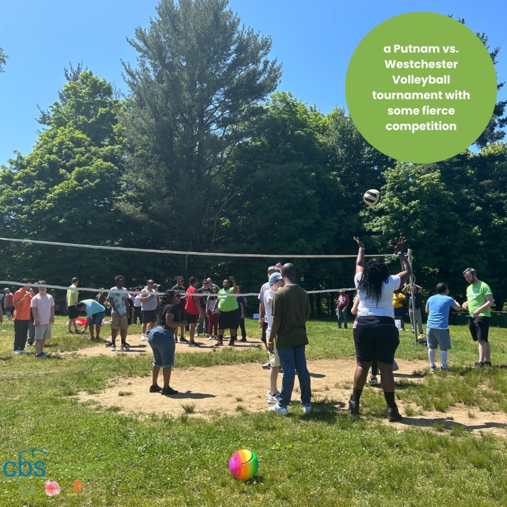 Friends, individuals with disabilities, and direct support professionals play each other in a game of volleyball during Field Day at FDR Park.