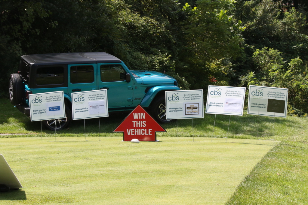 Pearl Blue Jeep Wrangler parked at golf club hole #12.