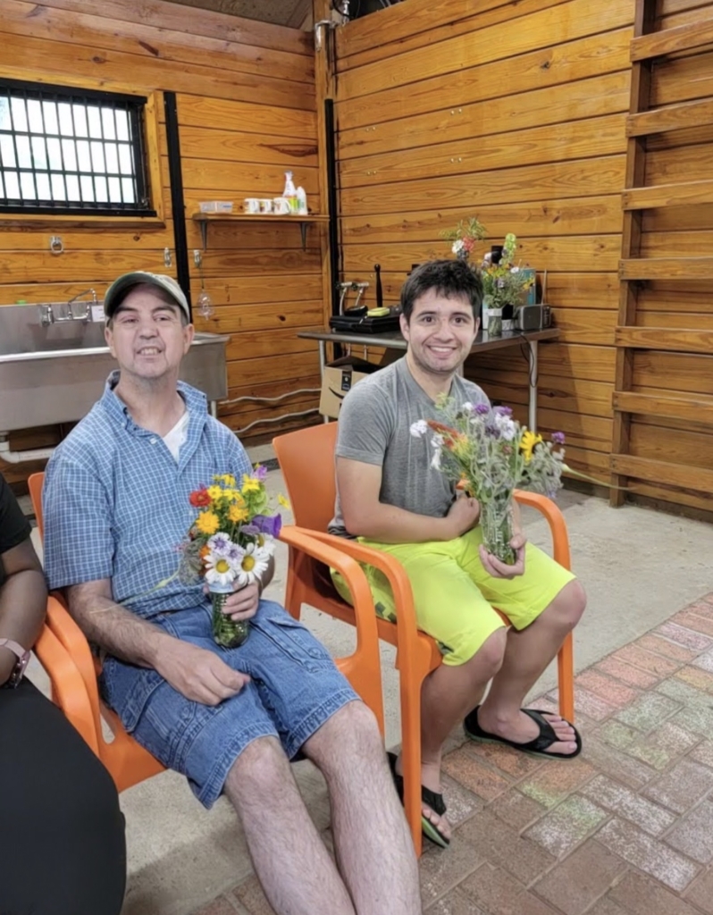 People with disabilities connect with nature and create flower arrangements at Cultivating Dreams Farm, Community Based Service's farm that helps people with disabilities achieve their dreams.