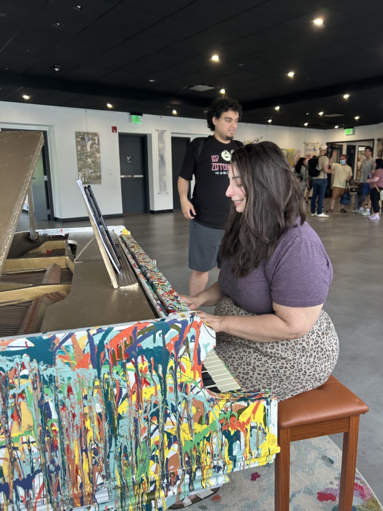 Krista Libertino, a music, theater, and movement teacher, playing the piano just before theater class starts.