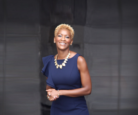 Portrait of Claudia Gordon in a blue dress and white necklace