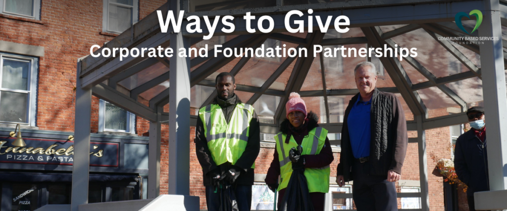 People in the CBS Supported Employment program stand with Job Developer Joe Conti under the atrium in historic Peekskill NY. They wear reflective work vests and exude confidence through their work and partnership with Win Waste.