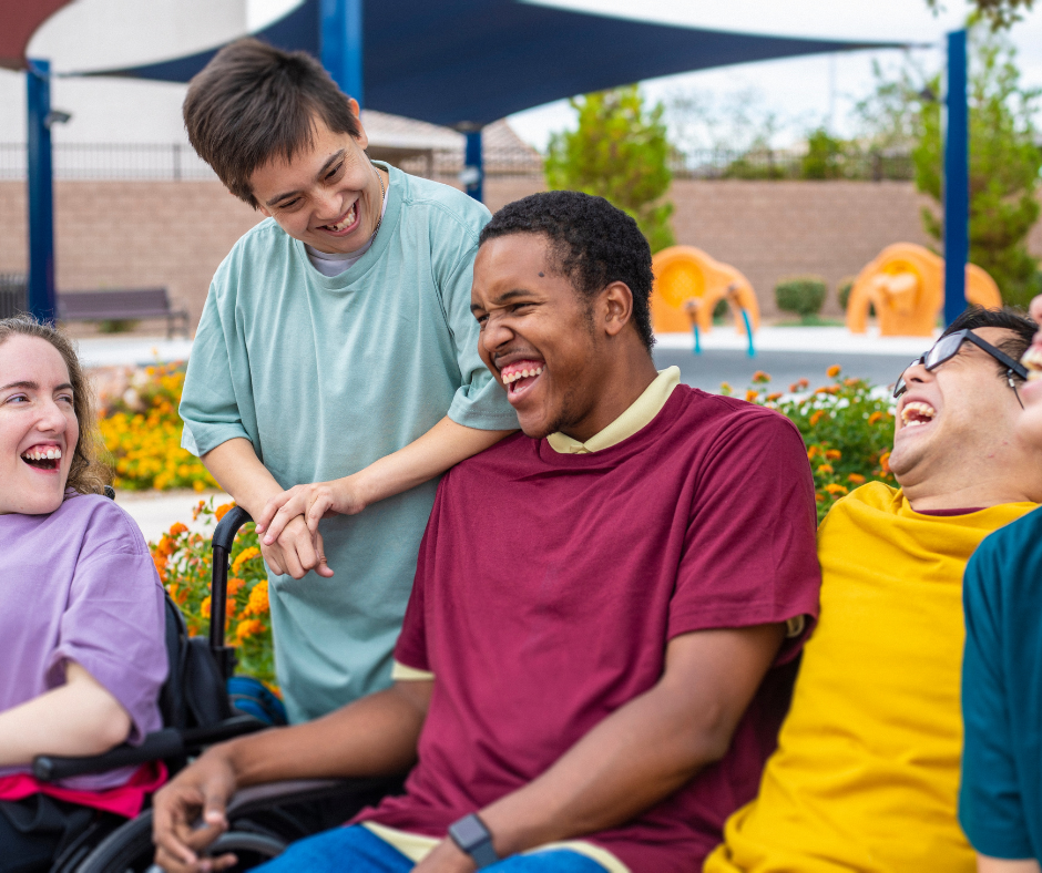 Friends who live together in a group home are out at the community pool laughing and having a great time together.
