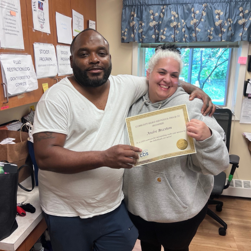 Nominee for CBS Employee of the Year DSP Andre Braxton with house manager Lisa Cuccinella as he holds his certificate