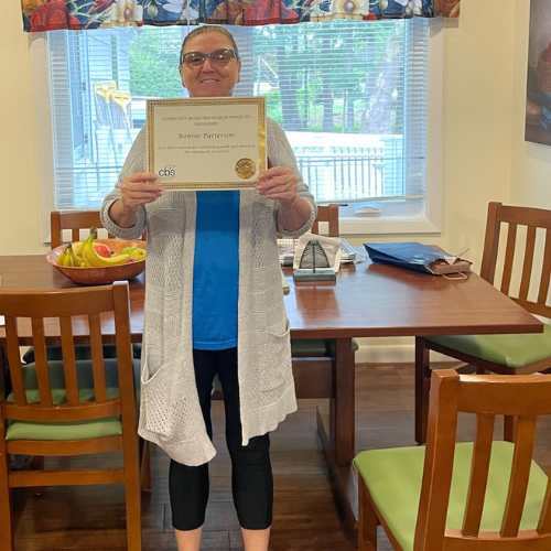 Bonnie Patterson DSP nominee for Employee of the Year at CBS holds up her certificate