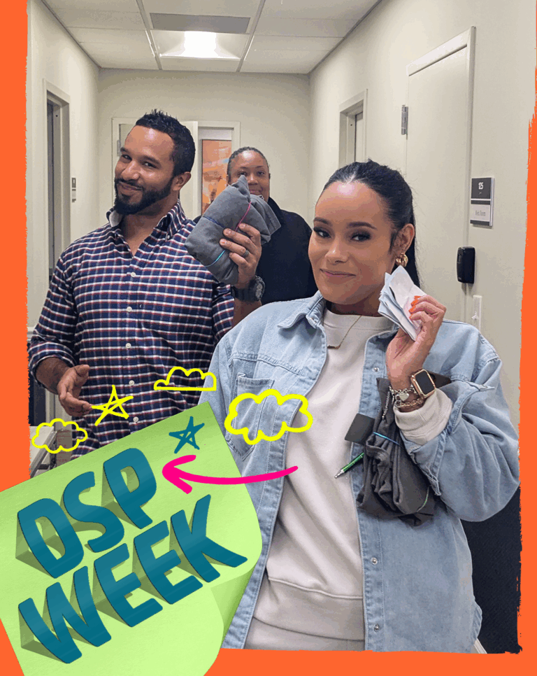 DSPs in the Site Based Day Program of CBS hold up the prizes they found during a scavenger hunt activity.