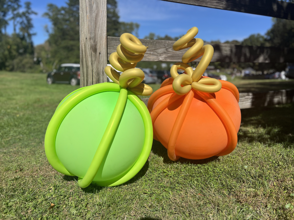 green and orange balloons with gold vines created out of balloons by Gwendy Balloon Artist