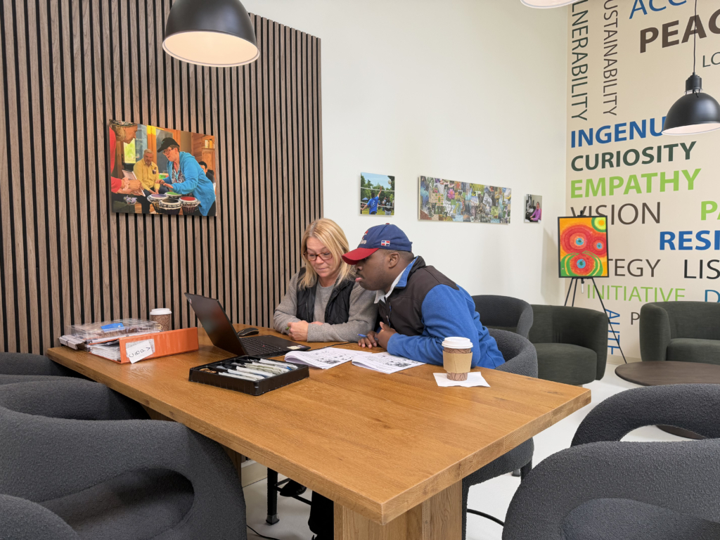A job coach and a person learning job skills work together one on one at the Impact Center for Learning.