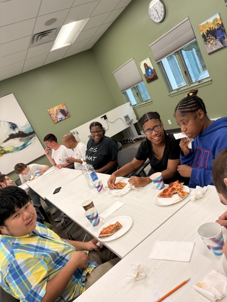 People in the Project Friendship Advocacy group meet for a pizza party.