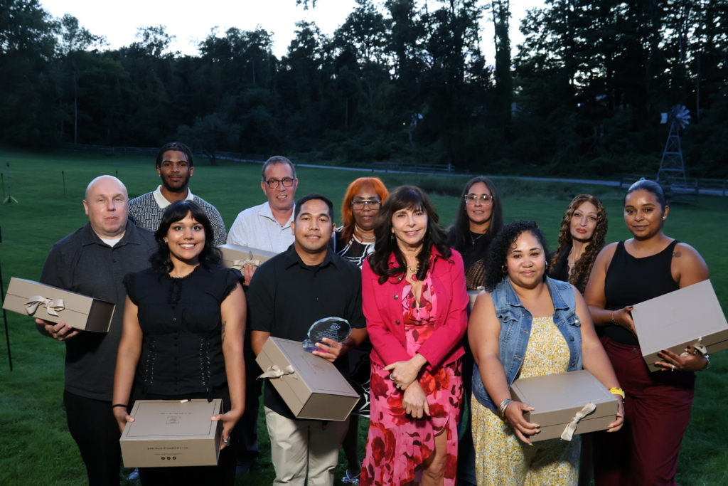 Nominees for CBS Employee of the year gather with CEO Vicki M. Sylvester, PhD at Cultivating Dreams farm for the awards ceremony. The nominees hold gift boxes.