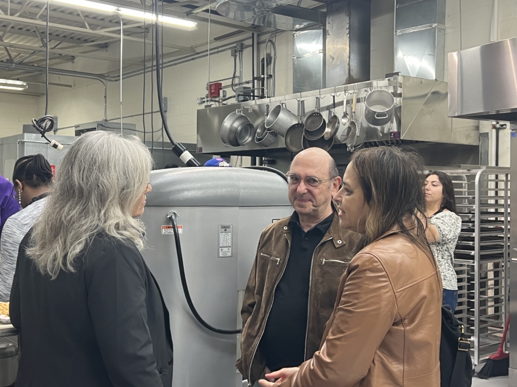 Parents Ed Baum and Lise Sharfin speak with Westchester County Legislator Erika Pierce inside Good Reasons Dog Treat bakery