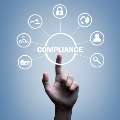 A hand pointing to the word compliance on a diagram